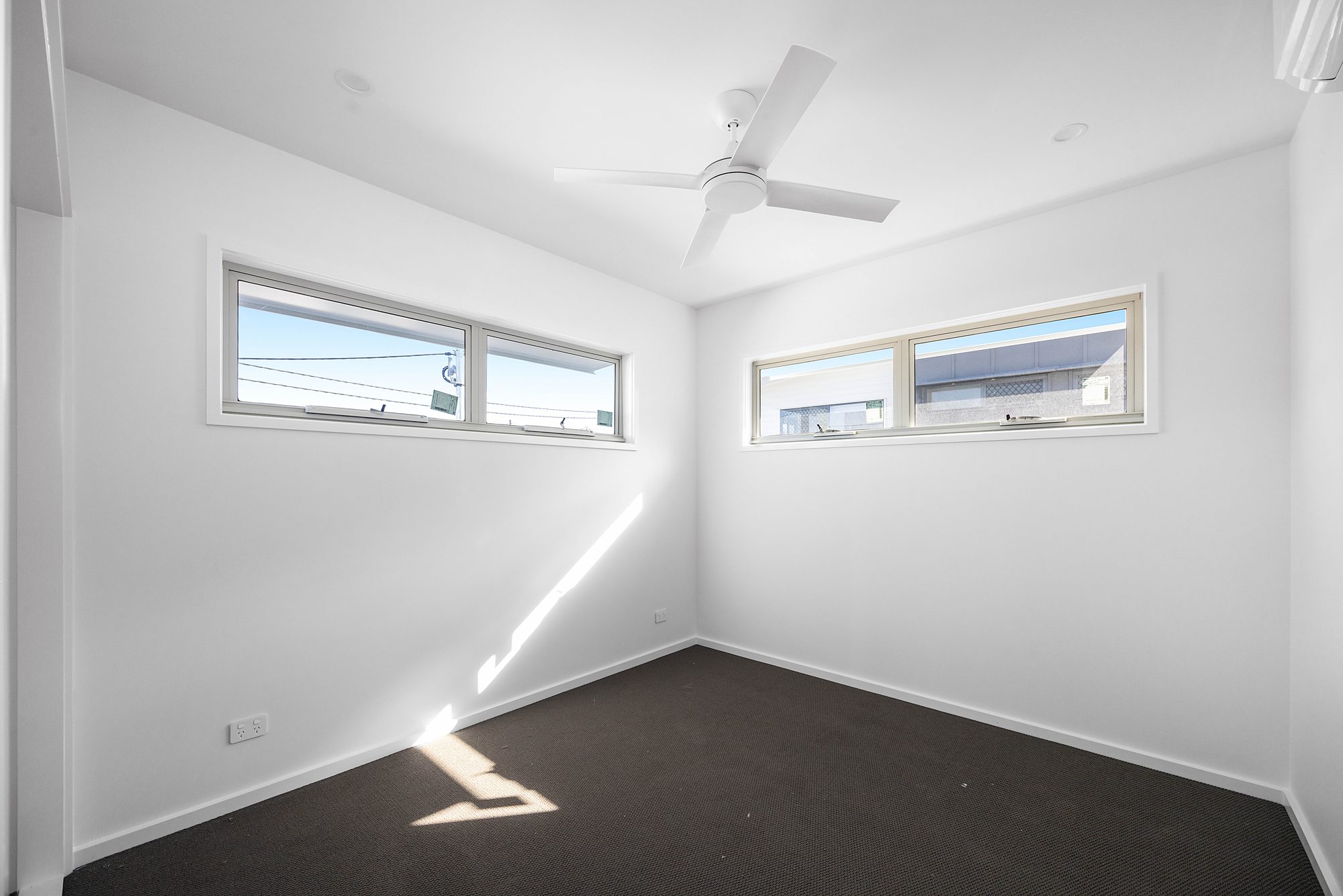 Photo of a completed Sanctuary Beerwah bedroom with carpet and ceiling fan
