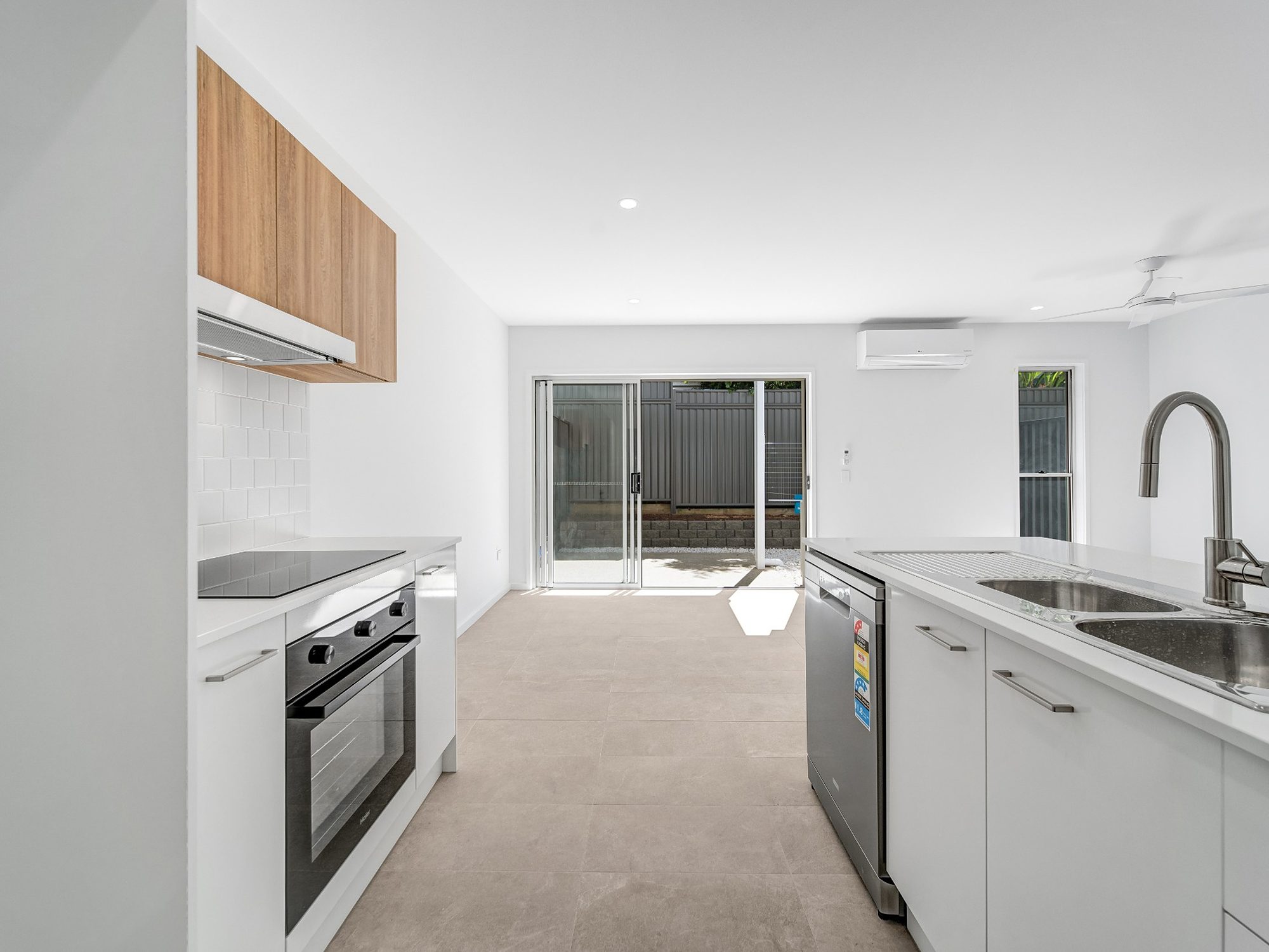 Completed open-plan kitchen and living area opening to the courtyard