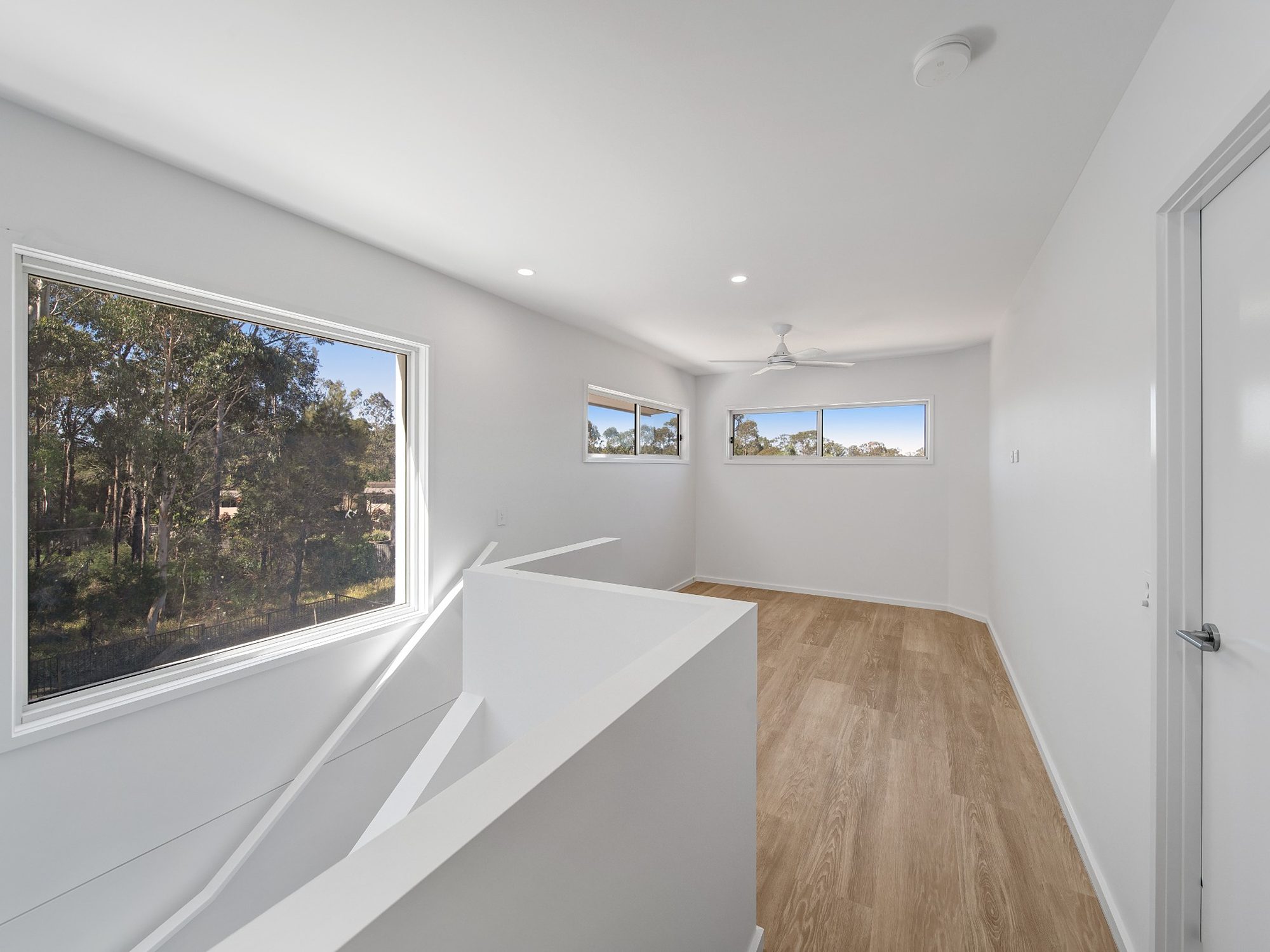 Completed upper-level living area with timber-look flooring