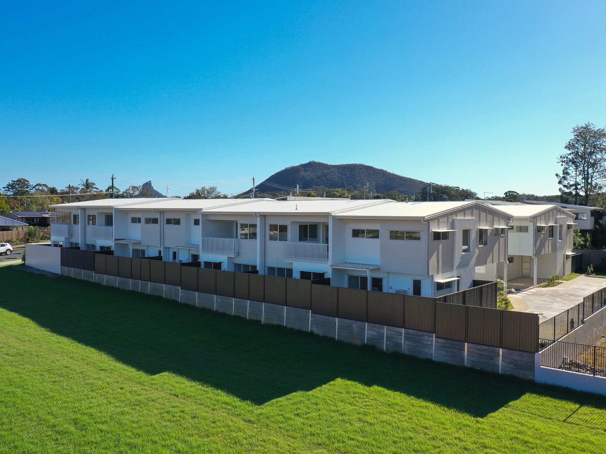 Completed Sanctuary Beerwah townhomes with the Glasshouse Mountains behind